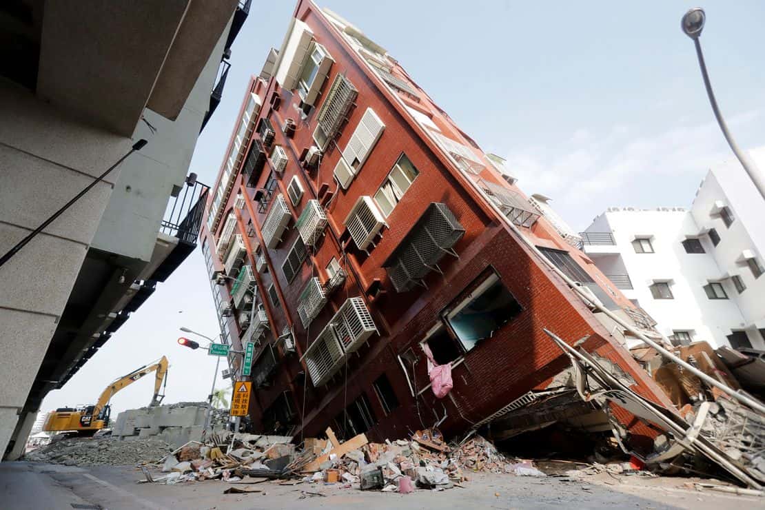 Debris surrounds a titled building a day after a powerful earthquake struck in Hualien City.
